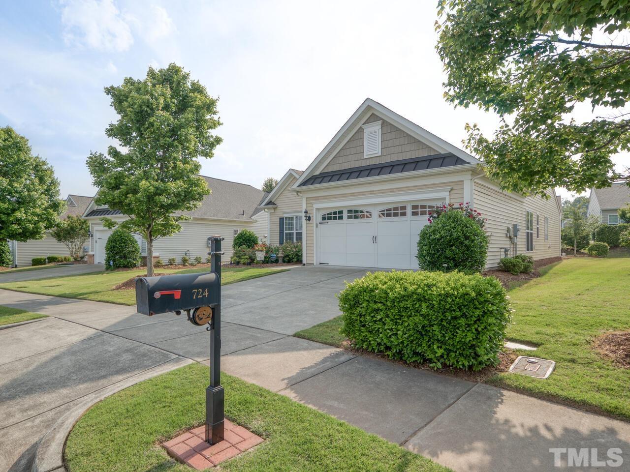 724 Eldridge Loop Cary, NC 27519 - Photo 36 of 38 a front view of a house with a yard and a garage