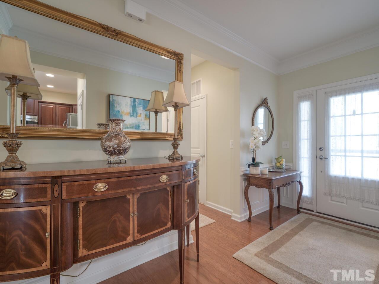 724 Eldridge Loop Cary, NC 27519 - Photo 4 of 38 a room with furniture a mirror and wooden floor