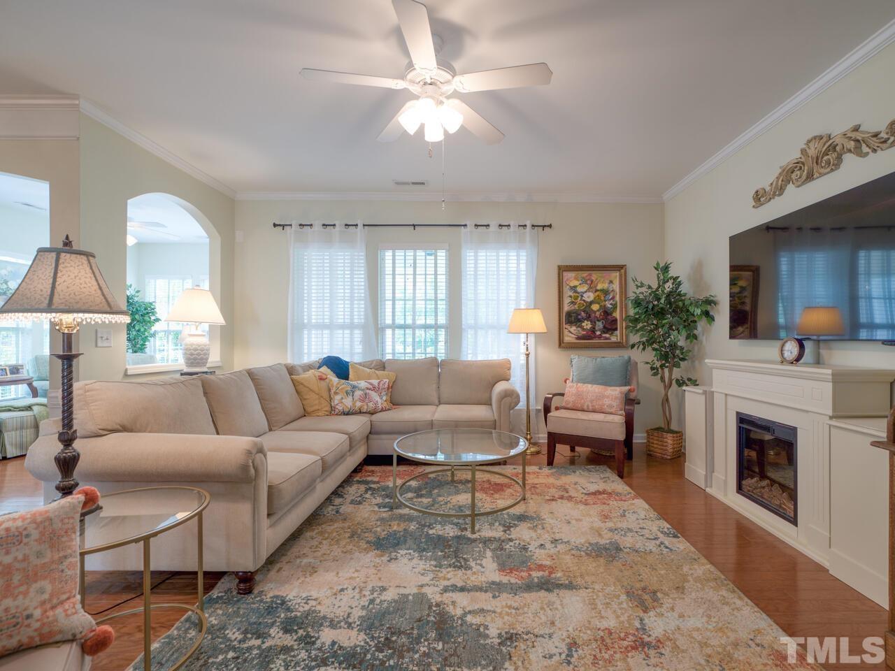 724 Eldridge Loop Cary, NC 27519 - Photo 7 of 38 a living room with furniture and a fireplace