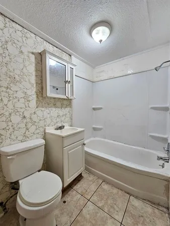 a bathroom with a toilet sink and bathtub