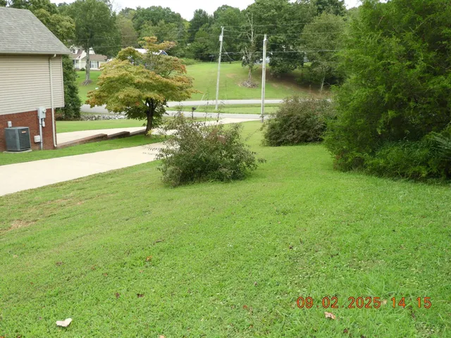 a kitchen with granite countertop a sink a stove and a microwave