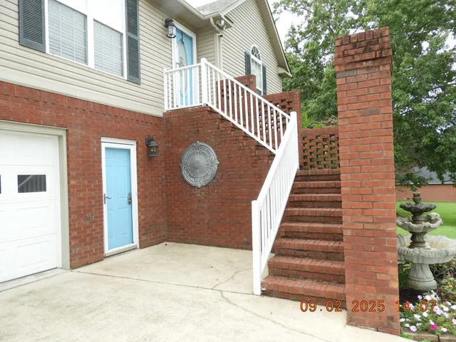a view of a house with wooden floor and fence
