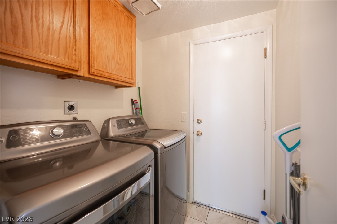 718 Rusty Spur Drive Henderson, NV 89014 - Photo 34 of 50 Functional laundry space featuring modern appliances and practical cabinetry.