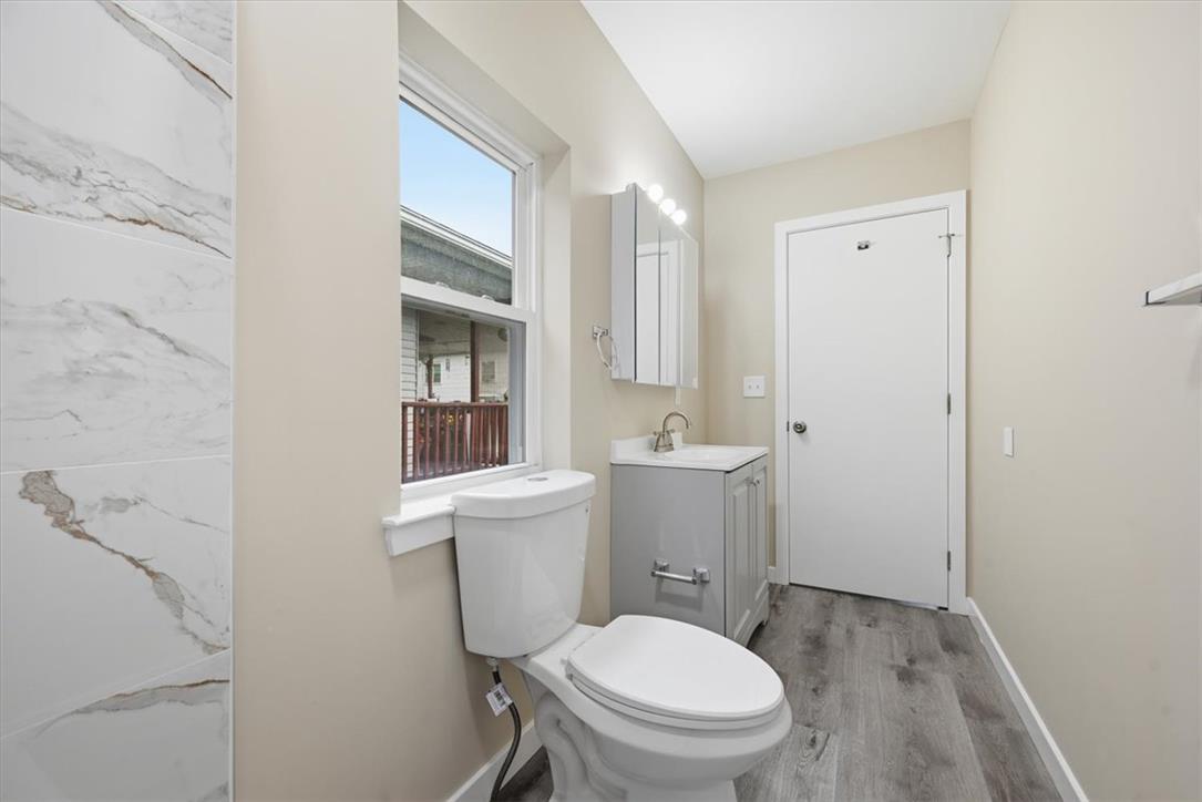 5641 North Coplay Road Whitehall, PA 18052 - Photo 32 of 68 A well-appointed bathroom offers sleek vanity and wood-look flooring.