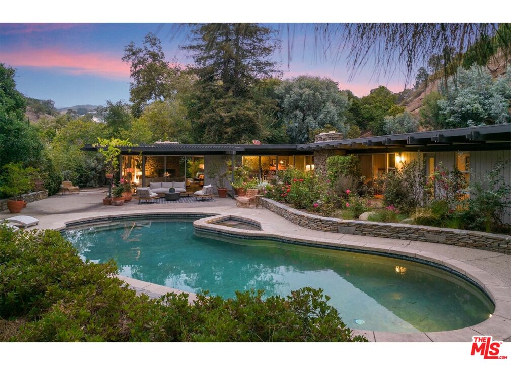 a swimming pool with trees in the background