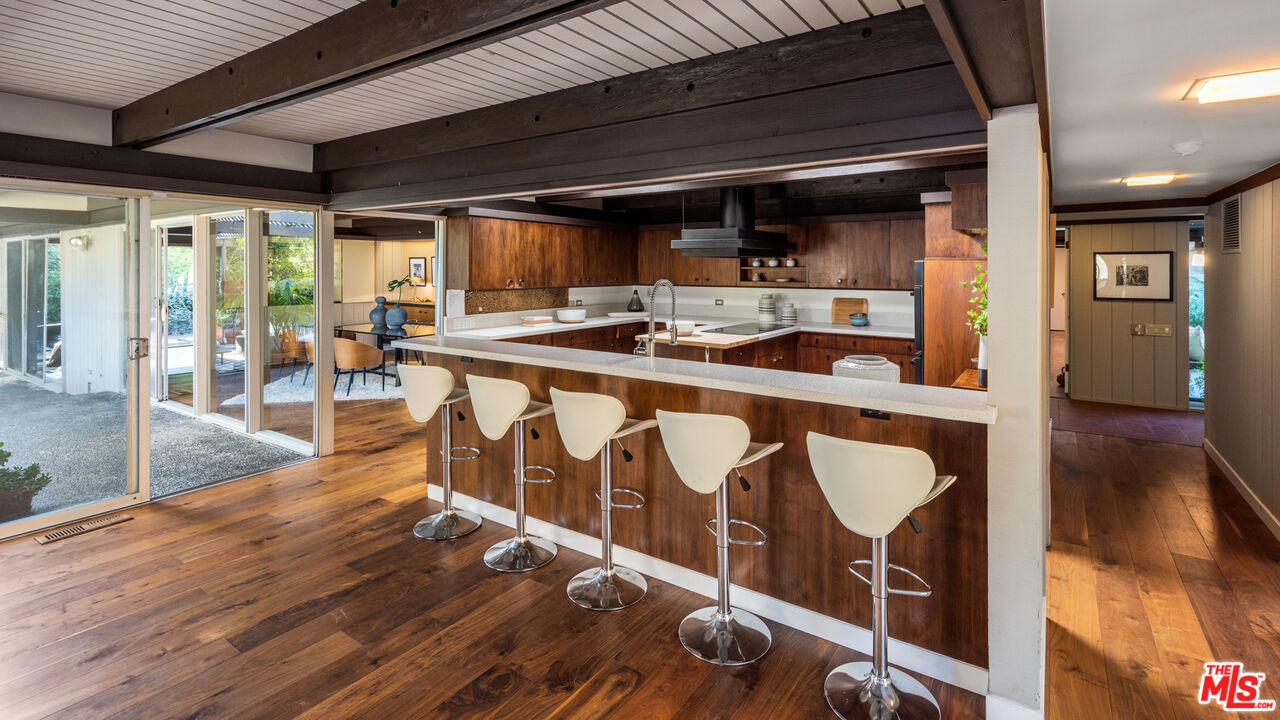 1030 Rivas Canyon Road Pacific Palisades, CA 90272 - Photo 11 of 42 a view of a kitchen with furniture and wooden floor