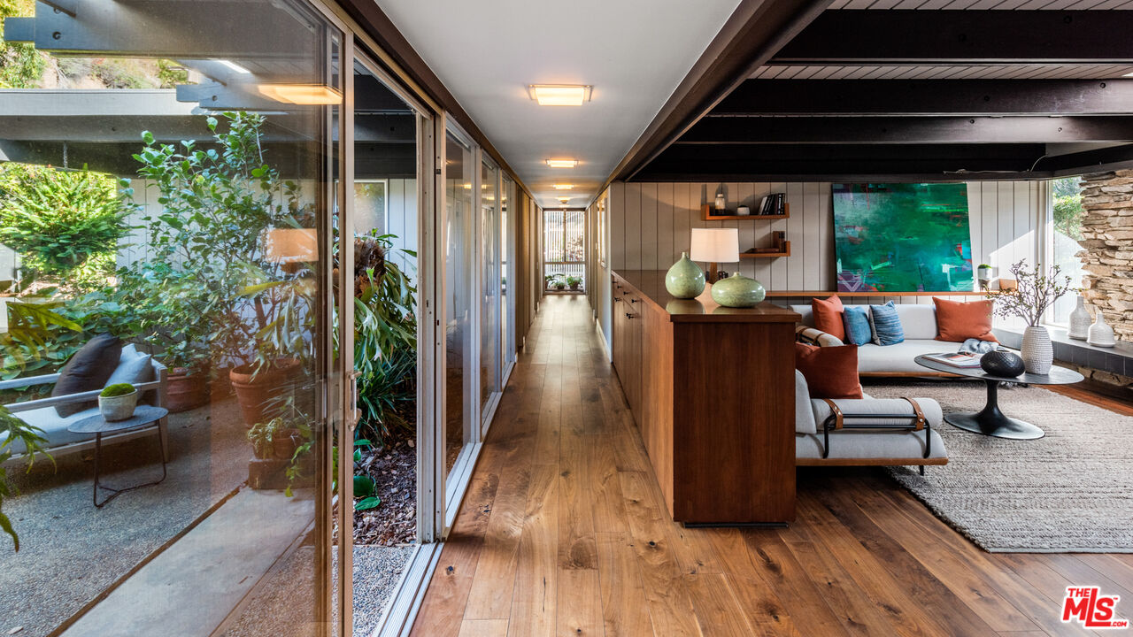 1030 Rivas Canyon Road Pacific Palisades, CA 90272 - Photo 13 of 42 a living room with furniture and wooden floor
