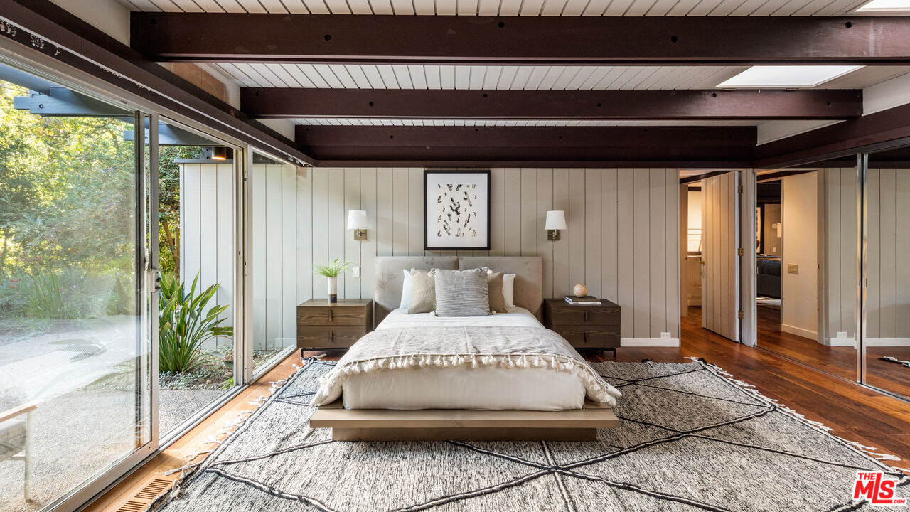 1030 Rivas Canyon Road Pacific Palisades, CA 90272 - Photo 14 of 42 a large bed sitting in a bedroom next to a window