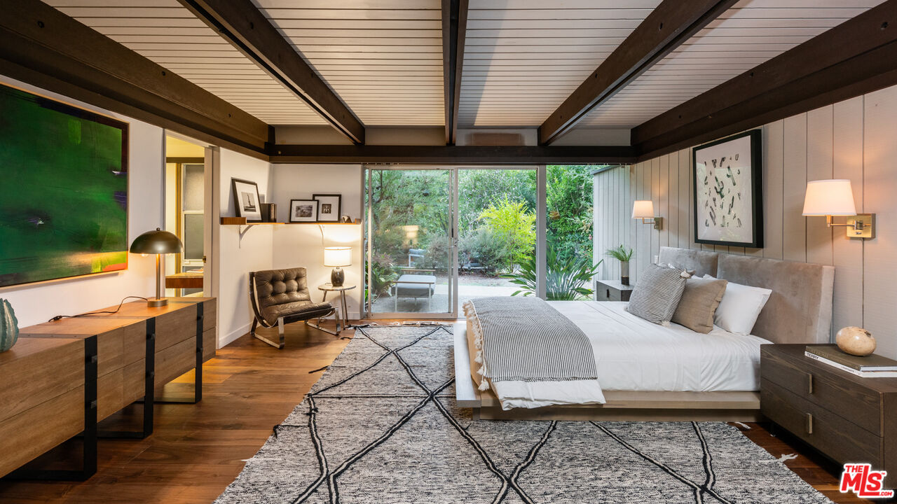 1030 Rivas Canyon Road Pacific Palisades, CA 90272 - Photo 15 of 42 a bedroom with furniture a bed and a large window