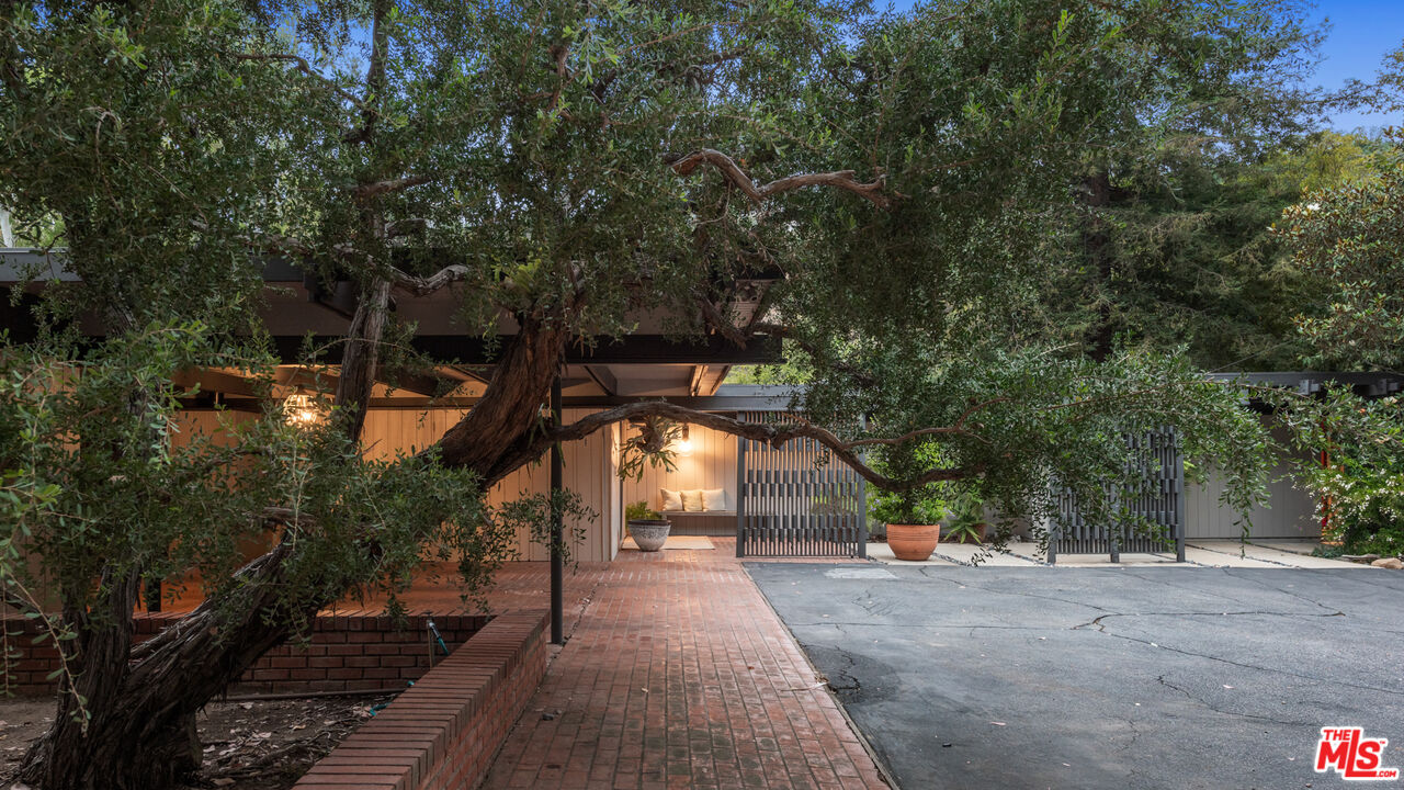 1030 Rivas Canyon Road Pacific Palisades, CA 90272 - Photo 2 of 42 a view of a house with a yard