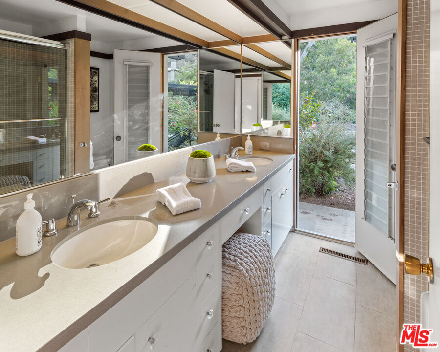 1030 Rivas Canyon Road Pacific Palisades, CA 90272 - Photo 21 of 42 a bathroom with sink and mirror