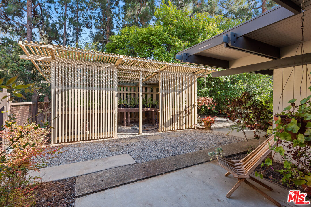 1030 Rivas Canyon Road Pacific Palisades, CA 90272 - Photo 30 of 42 a view of a chair and table in backyard of the house