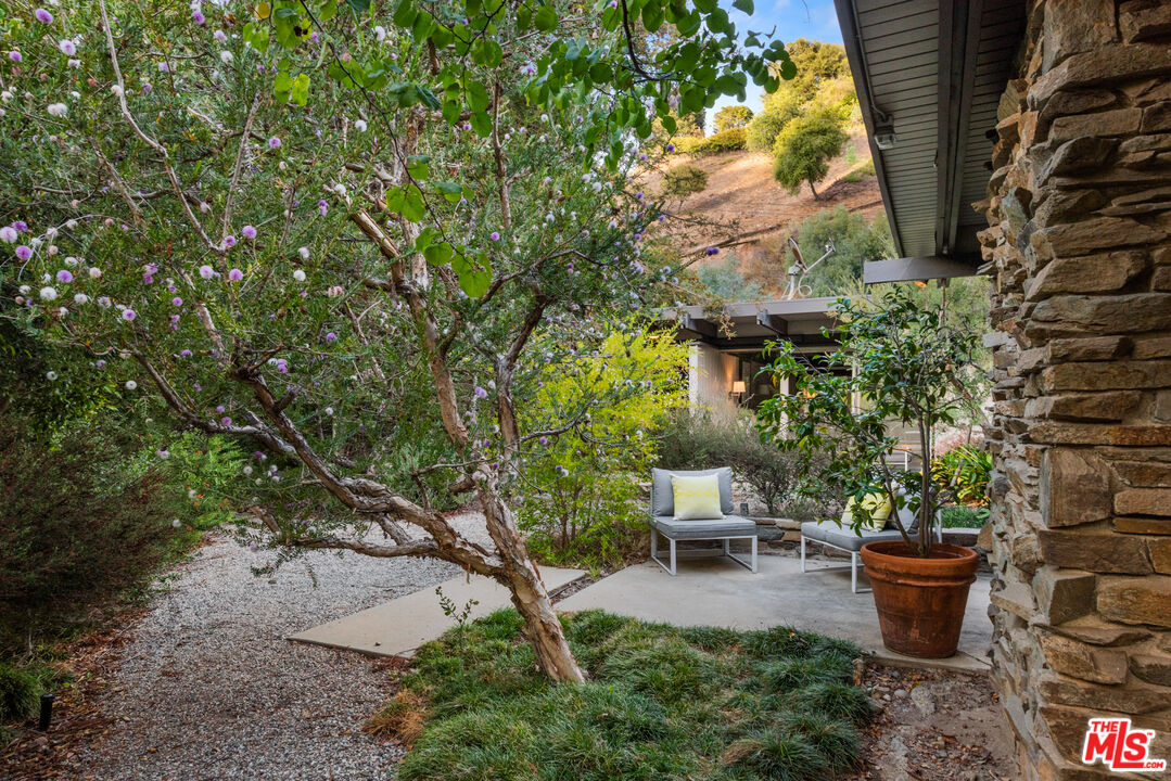 1030 Rivas Canyon Road Pacific Palisades, CA 90272 - Photo 31 of 42 a view of a backyard with patio and potted plants