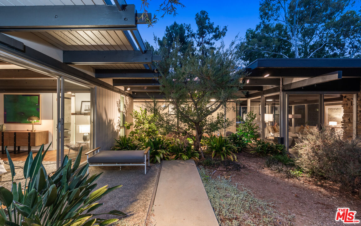 1030 Rivas Canyon Road Pacific Palisades, CA 90272 - Photo 33 of 42 a view of balcony with chairs and potted plants
