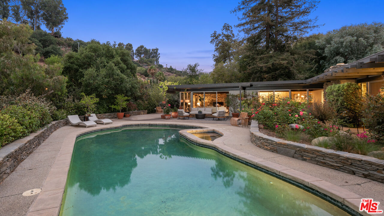 1030 Rivas Canyon Road Pacific Palisades, CA 90272 - Photo 34 of 42 a view of a swimming pool with a patio
