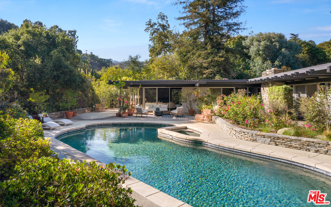 1030 Rivas Canyon Road Pacific Palisades, CA 90272 - Photo 35 of 42 a view of a swimming pool with a patio