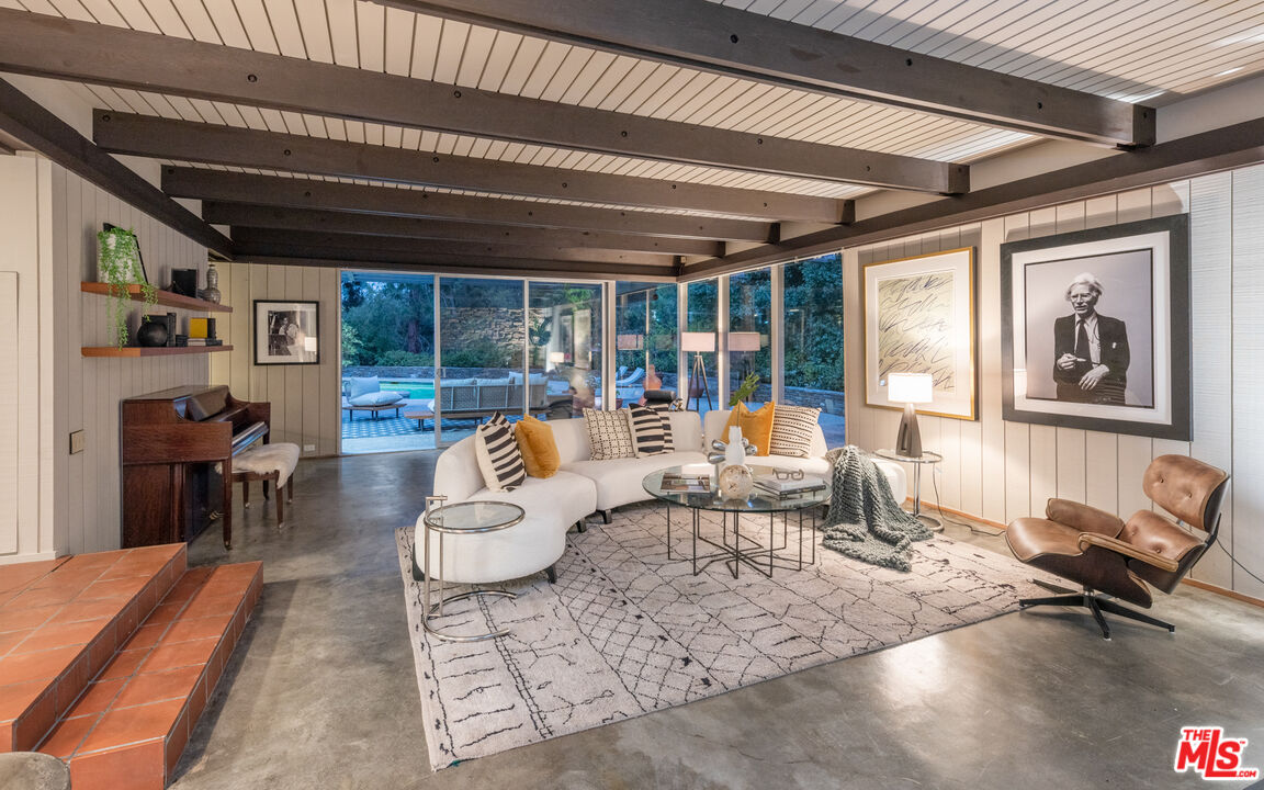 1030 Rivas Canyon Road Pacific Palisades, CA 90272 - Photo 6 of 42 a living room with furniture and a large window