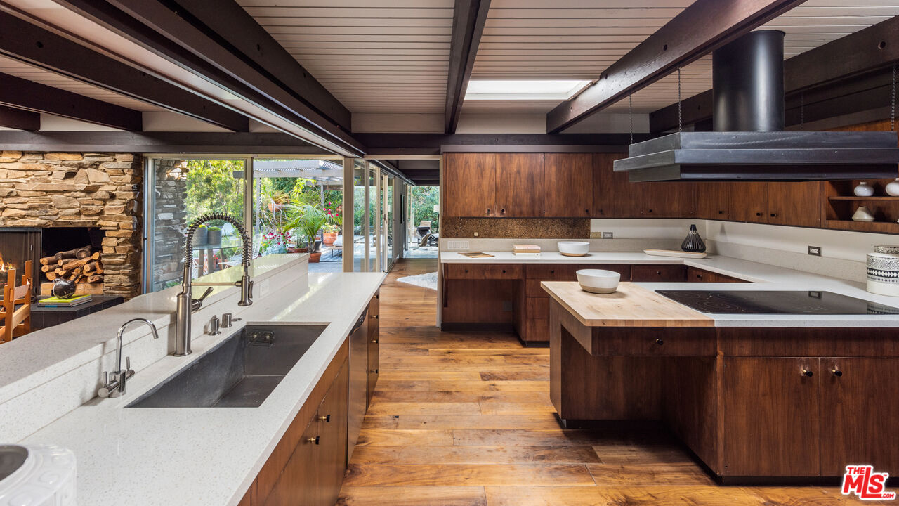 1030 Rivas Canyon Road Pacific Palisades, CA 90272 - Photo 9 of 42 a kitchen with a sink stove and cabinets