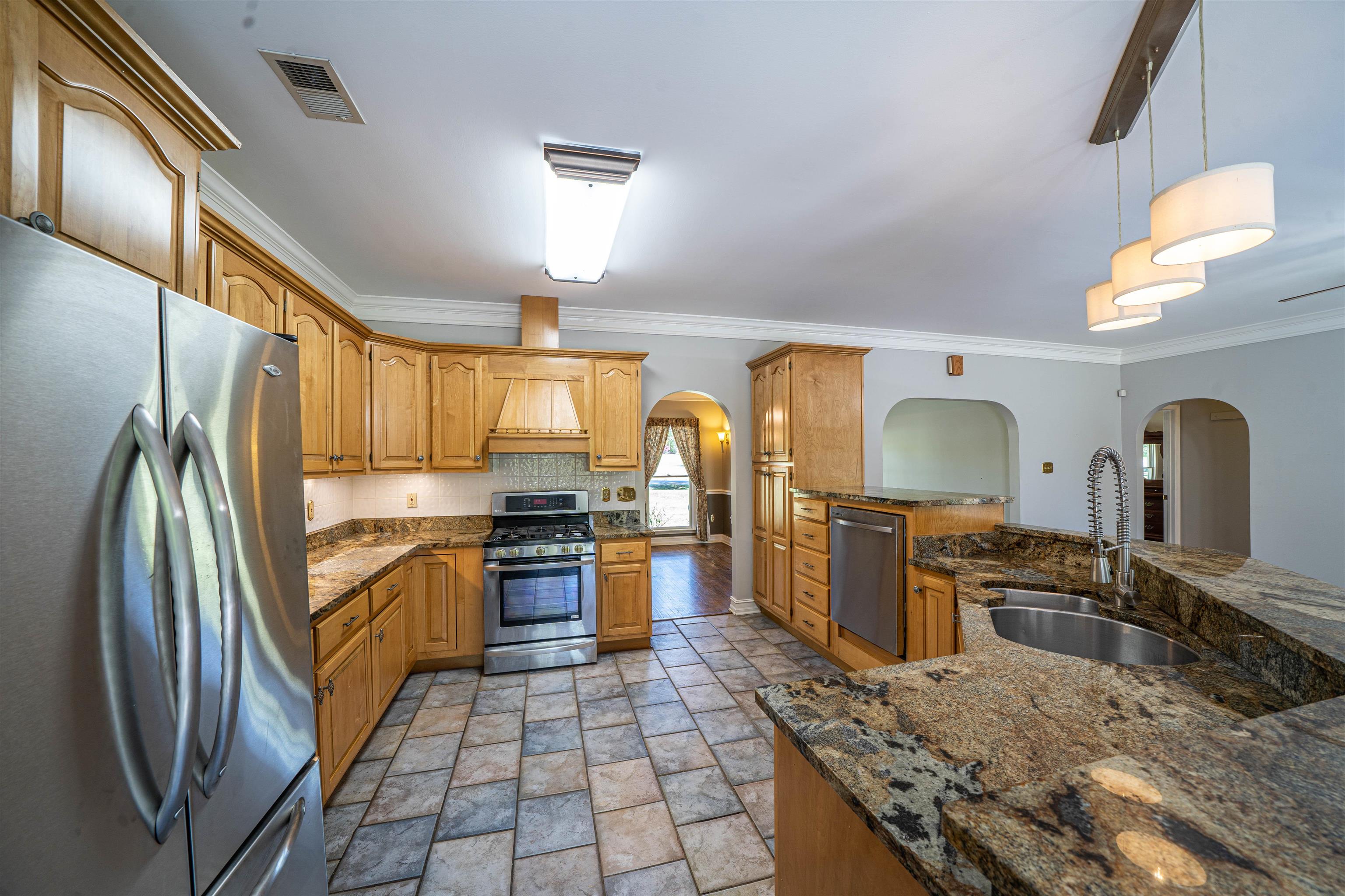 345 Allen Road Williston, TN 38076 - Photo 17 of 25 a kitchen with stainless steel appliances granite countertop a sink stove and refrigerator