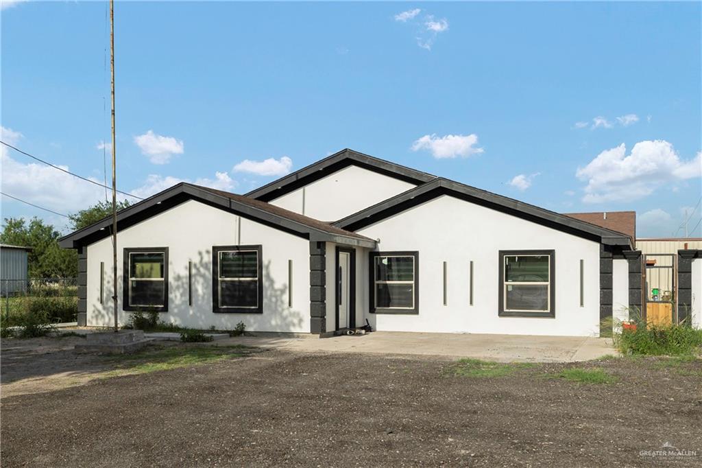 4407 North Raul Longoria Road San Juan, TX 78589 - Photo 1 of 22 a front view of a house with a garage