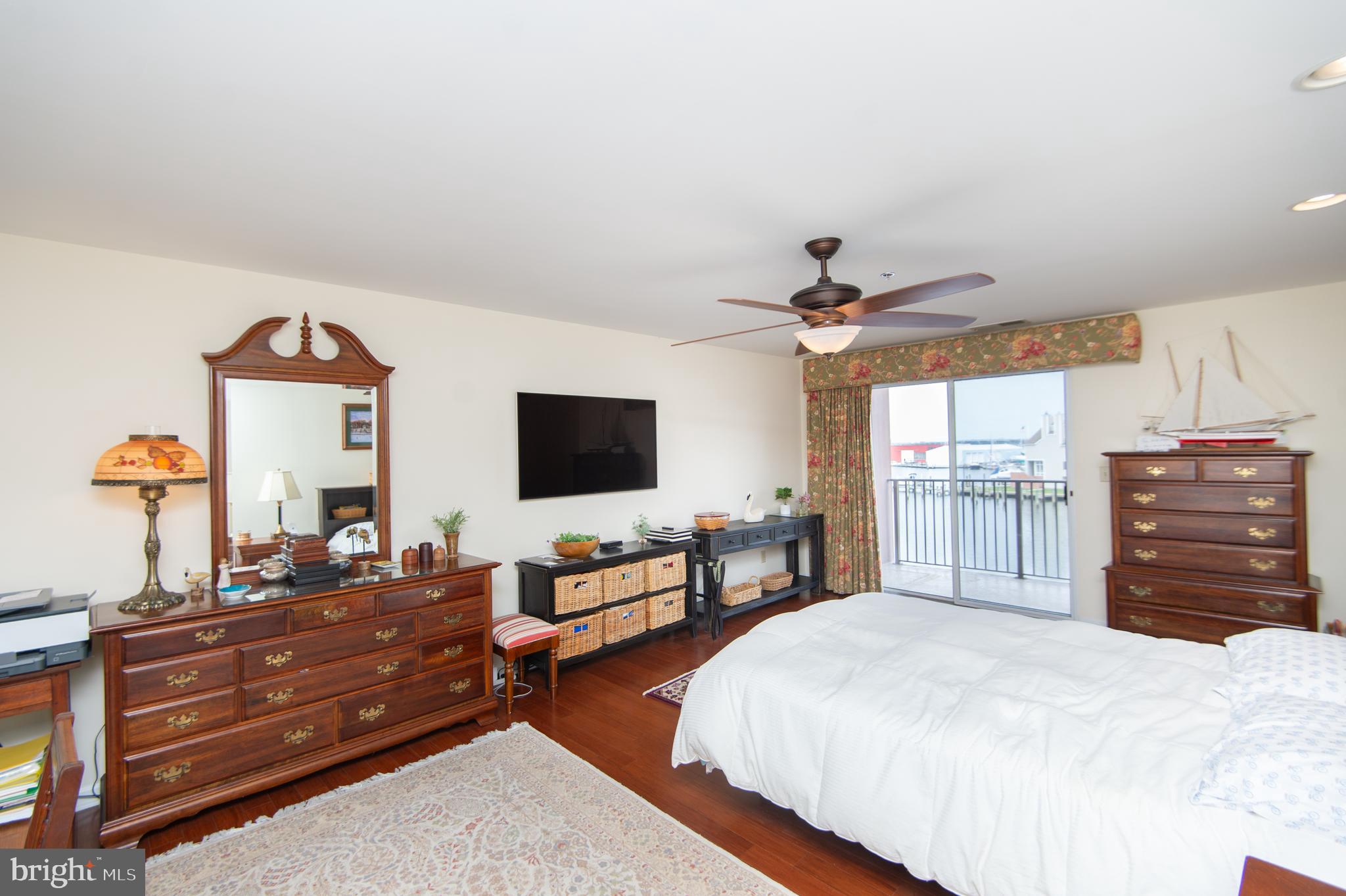 304 Academy Street, Unit 202 Cambridge, MD 21613 - Photo 13 of 40 Primary bedroom with balcony access.