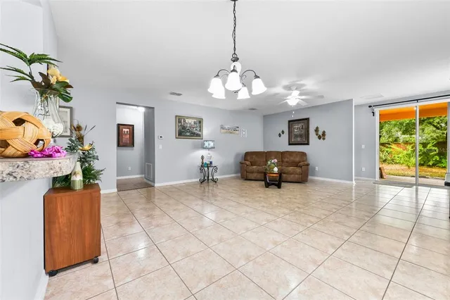 a living room with furniture and flowers