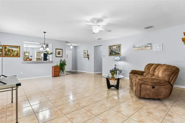 a living room with furniture and kitchen view