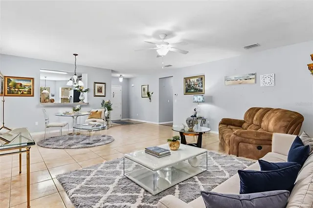 a living room with furniture and view of kitchen