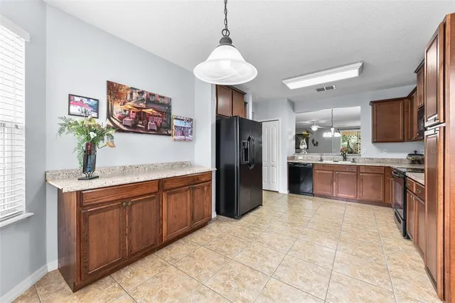 a kitchen with stainless steel appliances a refrigerator and a sink