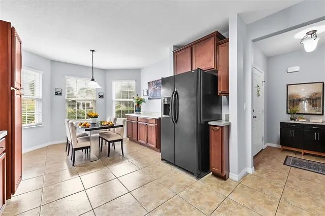 a kitchen with stainless steel appliances granite countertop a refrigerator and a stove top oven