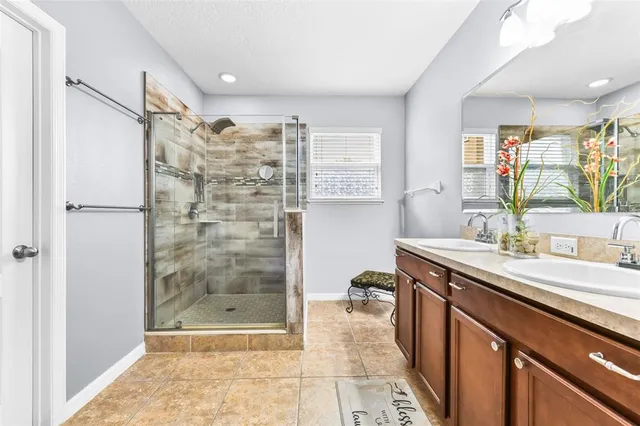 a bathroom with a shower sink and mirror