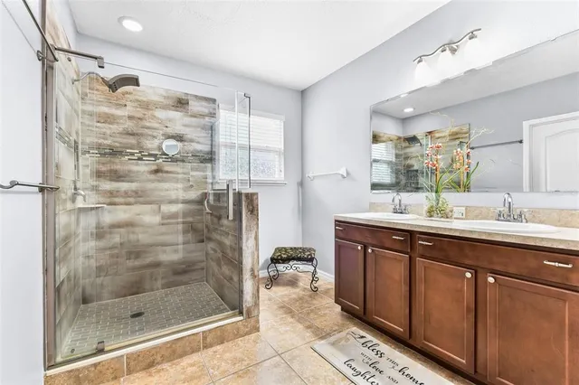 a bathroom with a shower sink and mirror