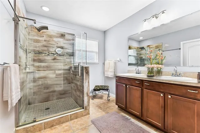 a bathroom with a shower sink and mirror