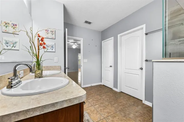 a bathroom with a double vanity sink mirror and shower