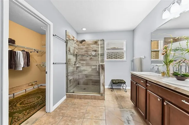 a bathroom with a granite countertop sink a toilet and shower