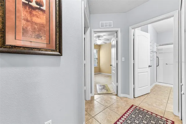 an empty room with a window and a ceiling fan