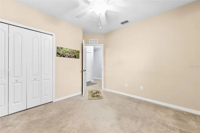 a bedroom with bed tv and window