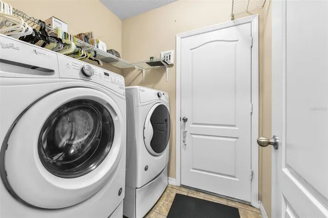 a view of a house with a yard and tree s