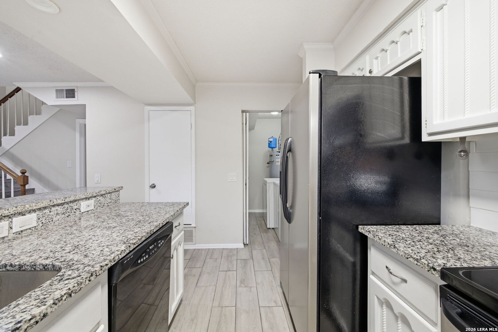 6106 Vance Jackson Road, Unit 15 San Antonio, TX 78230 - Photo 13 of 30 a kitchen with stainless steel appliances granite countertop a refrigerator and a sink