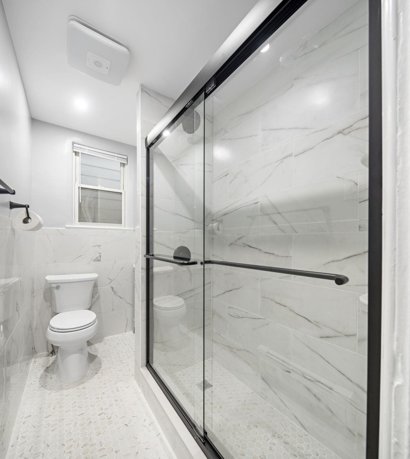 197 Hutton Street, Unit 1 Jersey City, NJ 07307 - Photo 12 of 15 a bathroom with a toilet and a shower