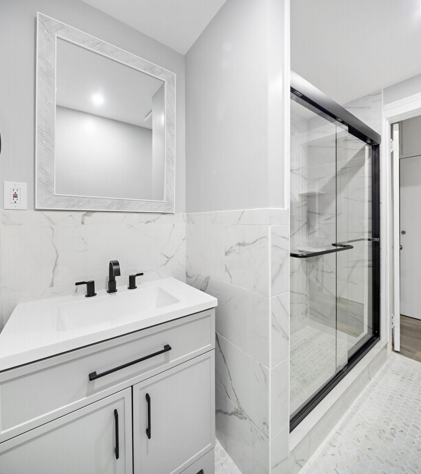 197 Hutton Street, Unit 1 Jersey City, NJ 07307 - Photo 14 of 15 a bathroom with a sink and a mirror