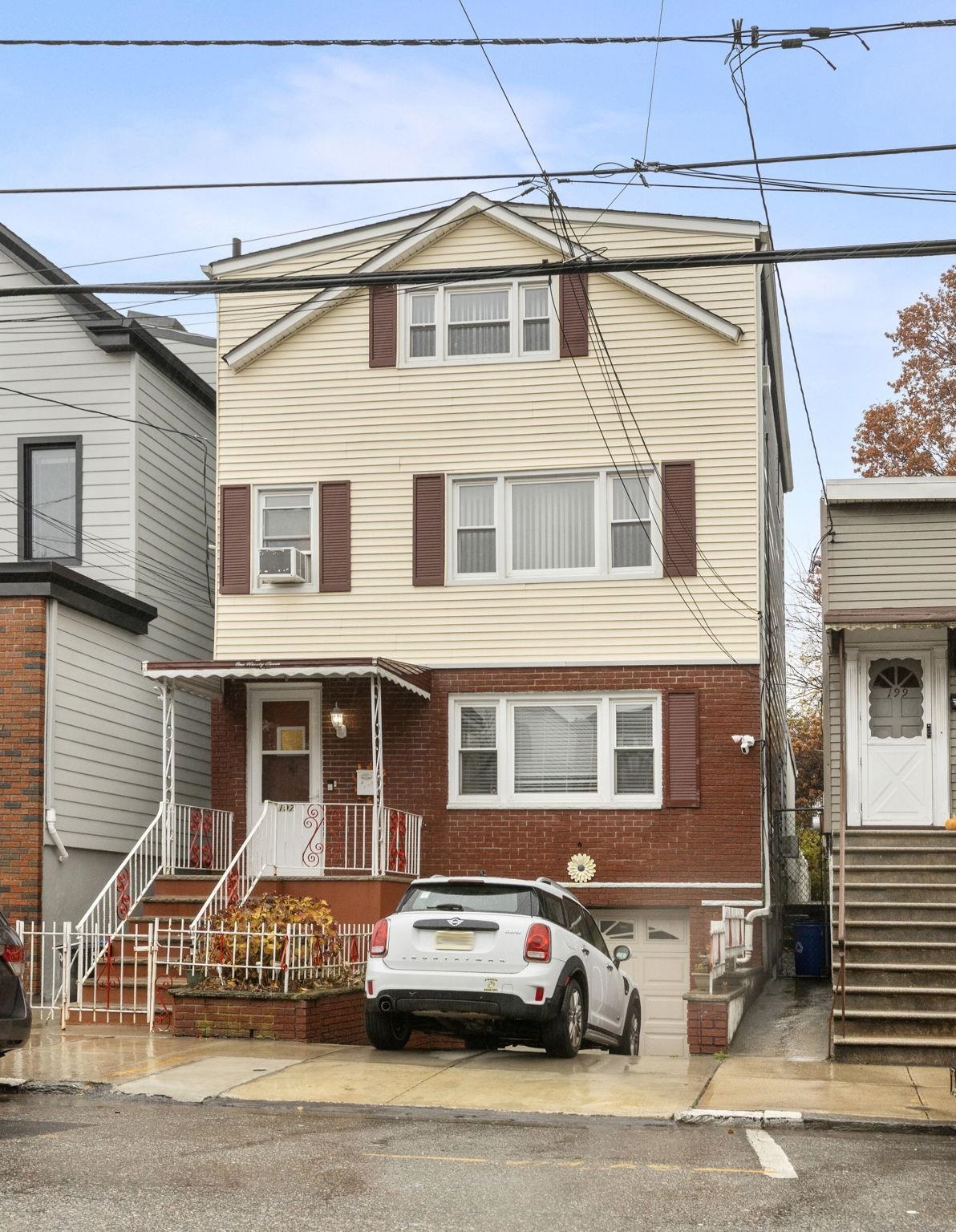 197 Hutton Street, Unit 1 Jersey City, NJ 07307 - Photo 15 of 15 a front view of a house with a parking space