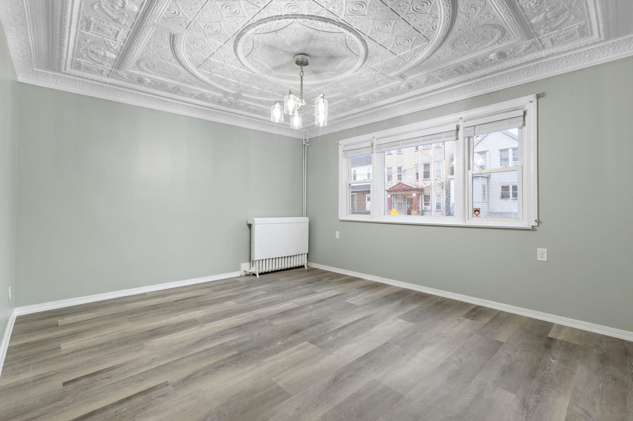197 Hutton Street, Unit 1 Jersey City, NJ 07307 - Photo 2 of 15 a view of an empty room with a window