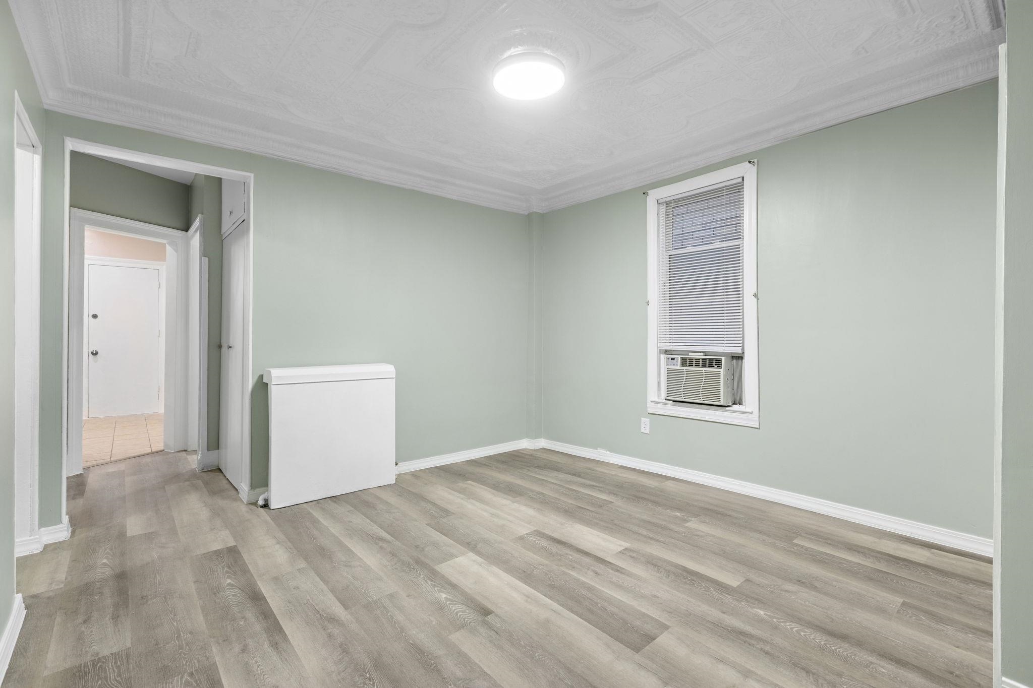 197 Hutton Street, Unit 1 Jersey City, NJ 07307 - Photo 4 of 15 a view of empty room with windows