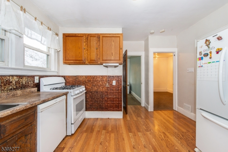 16 Willet Street Bloomfield, NJ 07003 - Photo 14 of 19 a kitchen with stainless steel appliances granite countertop a sink stove and refrigerator