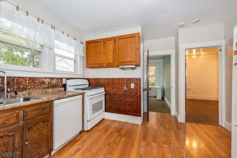 16 Willet Street Bloomfield, NJ 07003 - Photo 15 of 19 a kitchen with a sink and a wooden floor