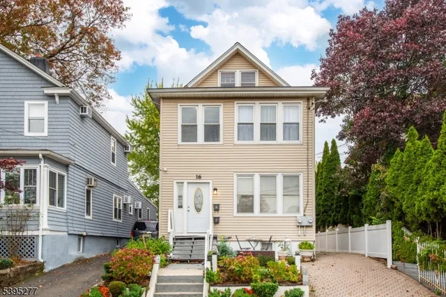 a front view of a house with a garden