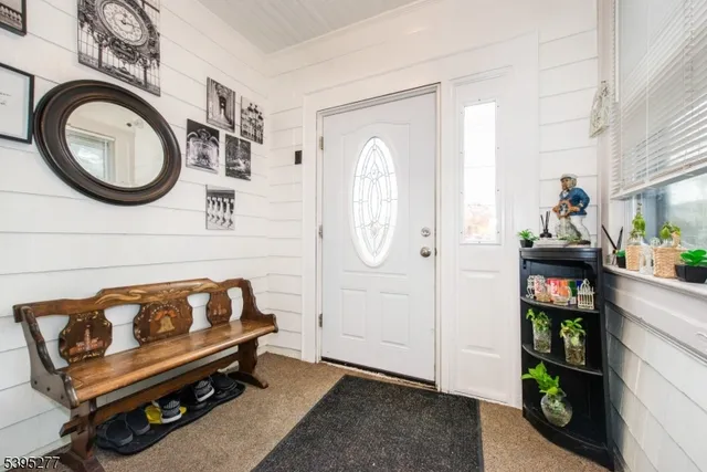 a living room with furniture and a wall clock