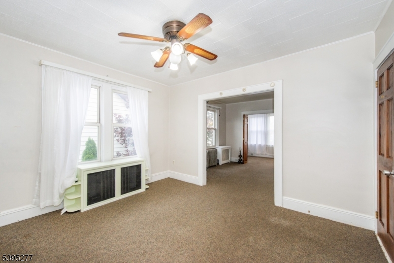 16 Willet Street Bloomfield, NJ 07003 - Photo 9 of 19 an empty room with windows and ceiling fan