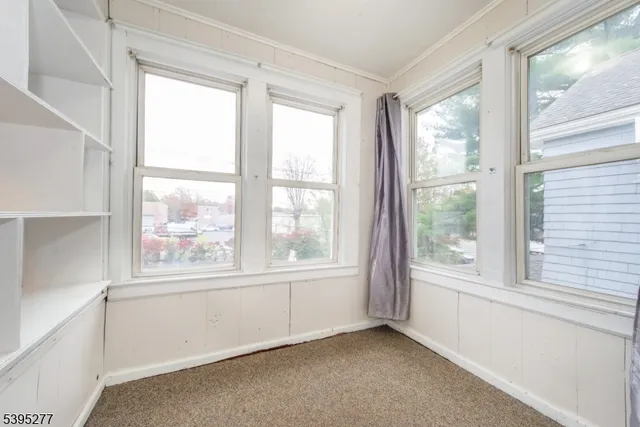 a view of room with a floor to ceiling window and an entryway